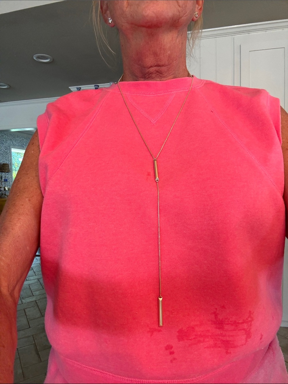 Kendra Scott Gold Lariat Necklace on Bright Coral Pink Top